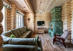 a living room filled with furniture and a fire place next to a wooden wall covered in logs