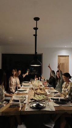 a group of people sitting around a wooden table