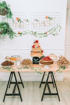 a table topped with lots of cakes and desserts