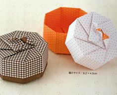 an origami box with a bow on the front and another one in the back