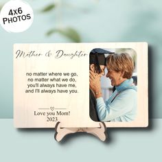 a wooden frame with an image of a woman holding a man's hand and the words, mother & daughter