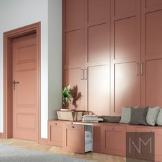 a living room with pink walls and wooden furniture in the corner, along with a plant