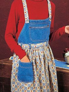 a woman wearing an apron and holding a teapot