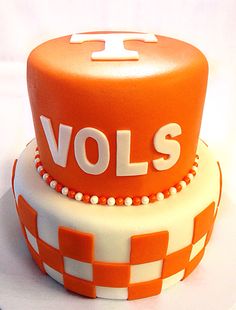 an orange and white cake with the word volls on it