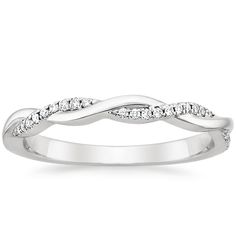 a white gold wedding ring with diamonds on the sides and an intertwined design in the middle