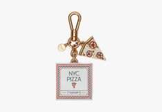 a key chain with a slice of pizza on it and a tag that says nyc pizza