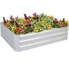 a white wooden planter filled with lots of different colored flowers and greenery growing in it