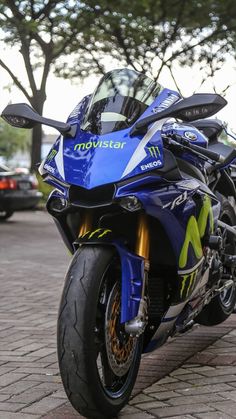 a blue motorcycle parked on the side of a road