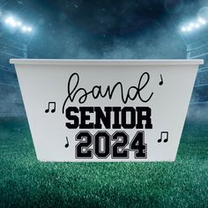 a white box with the words band senior on it in front of an empty stadium