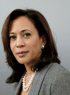 a woman wearing a suit and pearl necklace