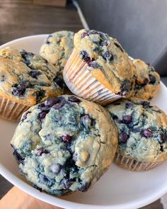 several blueberry muffins on a white plate