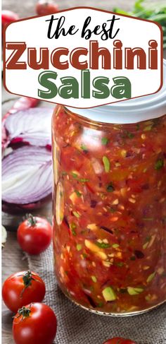 the best zucchini salsa in a glass jar with tomatoes and onions around it