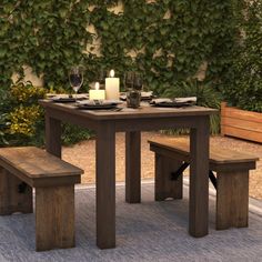 a wooden table with two benches next to it and a lit candle on the table