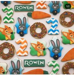 decorated cookies are arranged in the shape of animals and numbers for children's birthdays