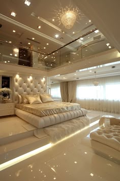 a large white bed sitting in the middle of a bedroom next to a chandelier