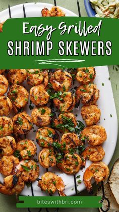 easy grilled shrimp skewers on a white plate with garlic and parsley