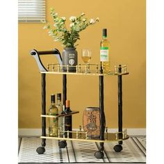 a bar cart with bottles and glasses on it