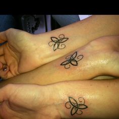 two women with butterfly tattoos on their legs