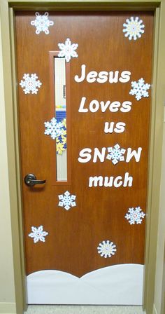 a door decorated with snowflakes and the words jesus loves us snwn much