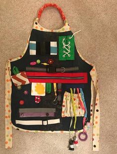 an apron made to look like it has various items on it and is hanging from the wall