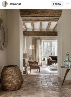 a living room filled with furniture and a large vase on top of a tile floor