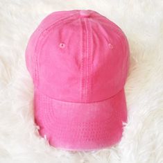 a pink hat laying on top of a white rug