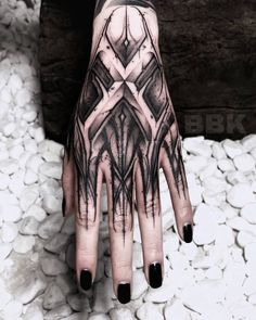 a person's hand with black and white designs on it