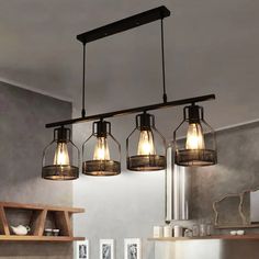 three lights hanging from the ceiling in a kitchen