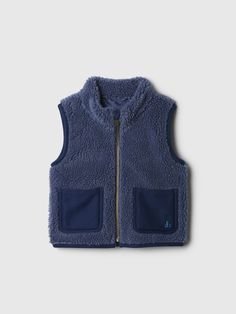 Soft sherpa vest.  Mockneck.  Sleeveless.  Zipper front.  Patch pockets at front.  Embroidered Brannan Bear at pocket.  This vest is made with 20% recycled polyester.  Compared to virgin materials, using recycled materials helps to reduce resource use and waste.  This product was made in a factory that invests in gender equality and women’s empowerment.  Through RISE Reimagining Industry to Support Equality) and Gap Inc. ’s program P. A. C. E.  Personal Advancement & Career Enhancement), we supp Sherpa Lined Vest, Toddler Faux Fur Vest, Boys Fleece Vest, Patagonia Bivy Vest, Gap Kids Boys, Sherpa Vest, Support People, Baby Gap, Holidays With Kids