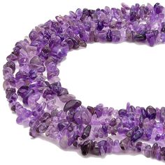 a strand of ametholite beads is shown in purple hues on a white background