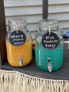 three jars filled with different colored liquids sitting on a table next to each other