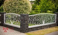 a brick fence with an ornamental design on it