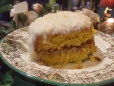 a piece of cake sitting on top of a white and green plate with frosting