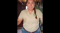 a woman with braids standing in front of a kitchen counter and refrigerator freezer