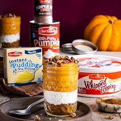 there are many different desserts in the jars on this table together, including pumpkin pie and whipped cream