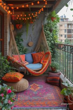 a hammock hanging from the side of a building next to potted plants