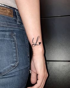 a woman with a small tattoo on her arm