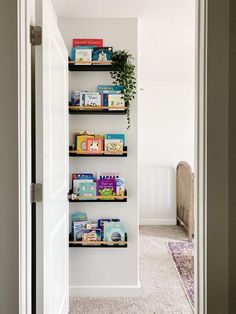 the bookshelves in this hallway are filled with children's books