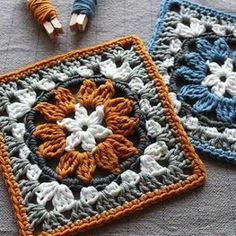 two crocheted squares sitting on top of a table