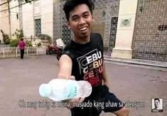 a young man holding a water bottle in his right hand