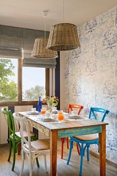 a dining room table with chairs and plates on it