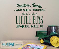 there is a wall decal that says tractors trucks and shiny trucks that's what the little boys are made of