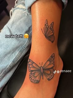 a woman's foot with two butterflies tattooed on the side of her leg and one is