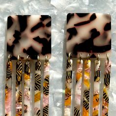 These earrings are all about movement! Features a bold square stud in a black and white tortoise acrylic with a contrasting pink, orange, white and black hand-swirled acrylic flirty fringe detail. ▪️Length: 3", Width: 1.25"▪️Materials: acrylic, brass base posts/jump rings with 18k gold plating▪️Hypoallergenic▪️All earrings come with specialized backs to maintain the integrity of the product. As with all fused materials please be mindful of your use of force. Handle with care. Small variations ca Afrocentric Accessories, Pink Tiger, Orange Square, Paper Earrings, Mini Hoop Earrings, Square Stud, Purse Strap, Black Hand, Pittsburgh Pa