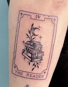 a black and white photo of a tattoo with books on it