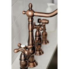 two faucets are shown on the counter top in this bathroom sink setting with white tile