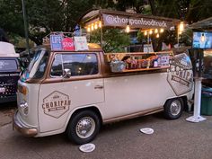 an old style food truck is parked on the side of the road near other vehicles