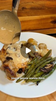 a plate with some food and a spoon on it that is being drizzled