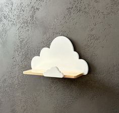 a white cloud shaped object mounted on the wall