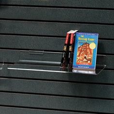 a couple of books sitting on top of a shelf